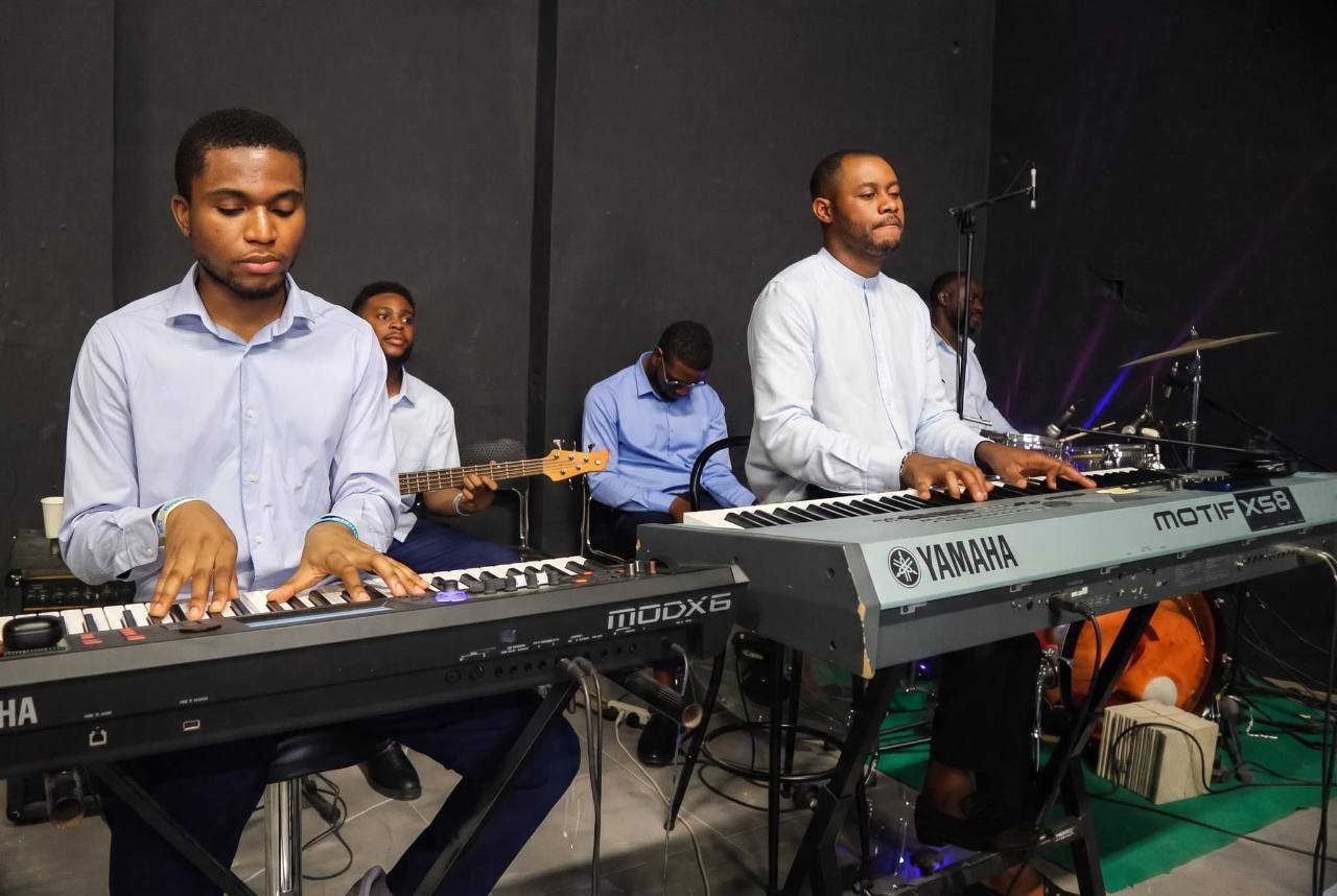 Musicians playing keyboards with the worship band at Rodwater